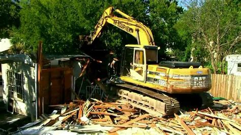 mini excavator tearing down house|abandoned house with mini excavator.